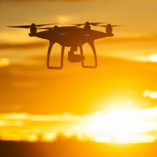 Flying drone at sunset